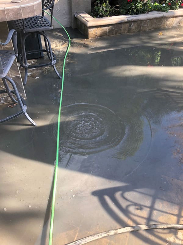 Dana Point house with clogged drain in backyard
