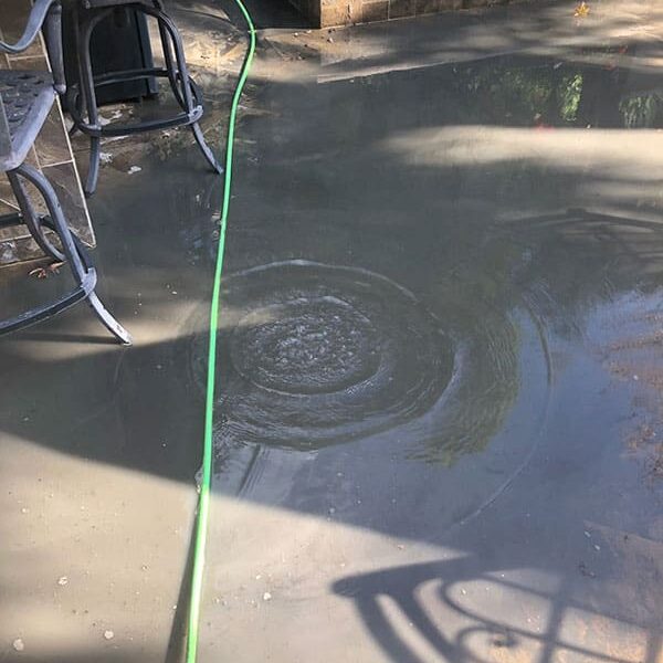 Dana Point house with clogged drain in backyard